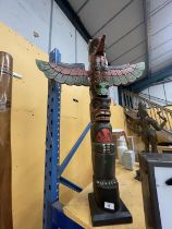 A CARVED WOODEN TOTEM POLE