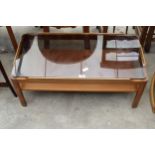 A RETRO TEAK TWO TIER COFFEE TABLE WITH SMOKED GLASS TOP, 34" X 17"