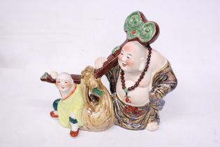 A CHINESE PORCELAIN BUDDHA WITH CHILD