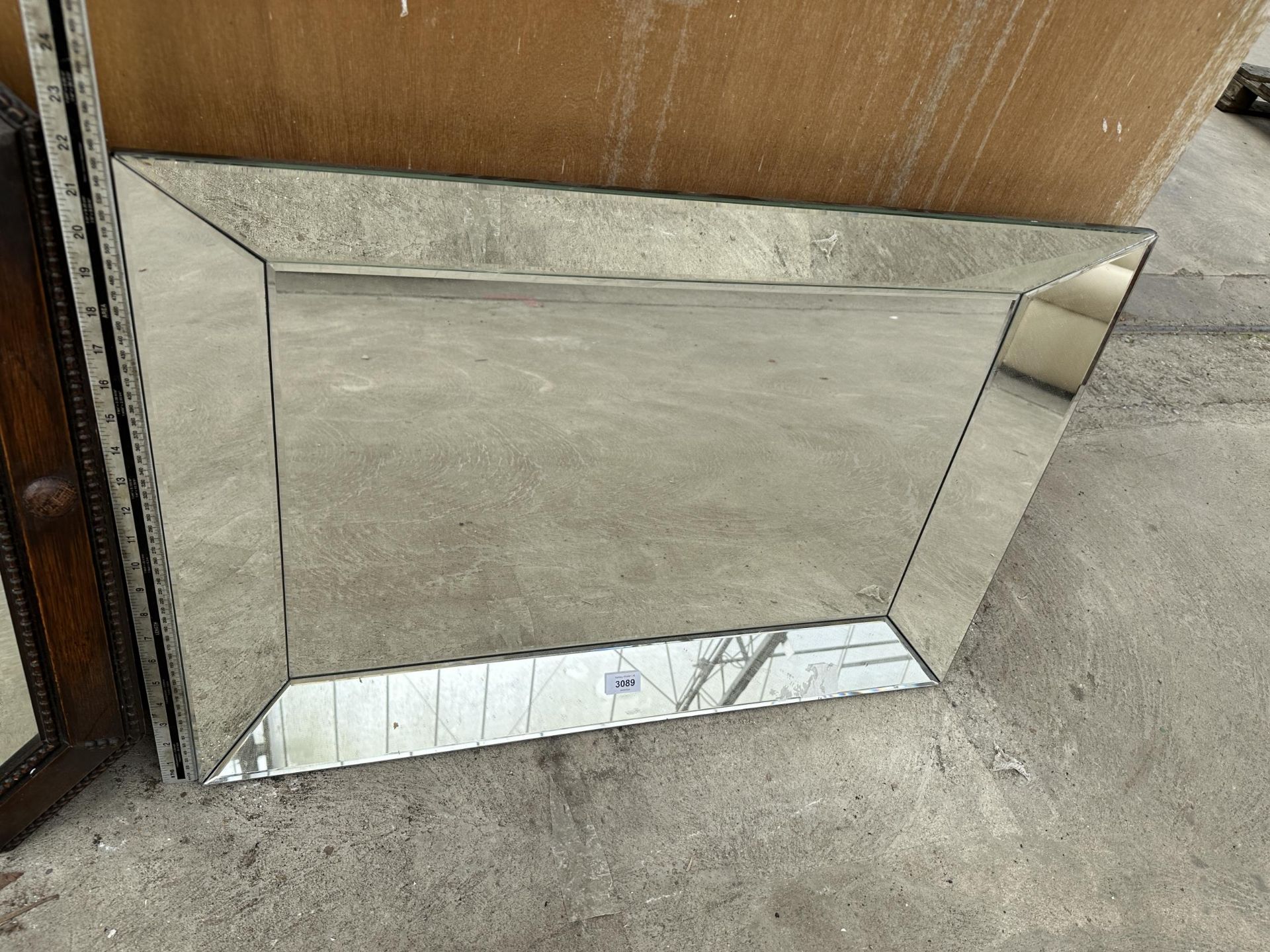 A BEVEL EDGE WALL MIRROR WITH ANGLED SIDE MIRRORS, 31" X 22"