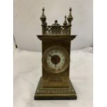 A VINTAGE BRASS MANTEL CLOCK ON A MARBLE BASE, WITH FOUR SPIRES TO THE TOP. WORKING WHEN