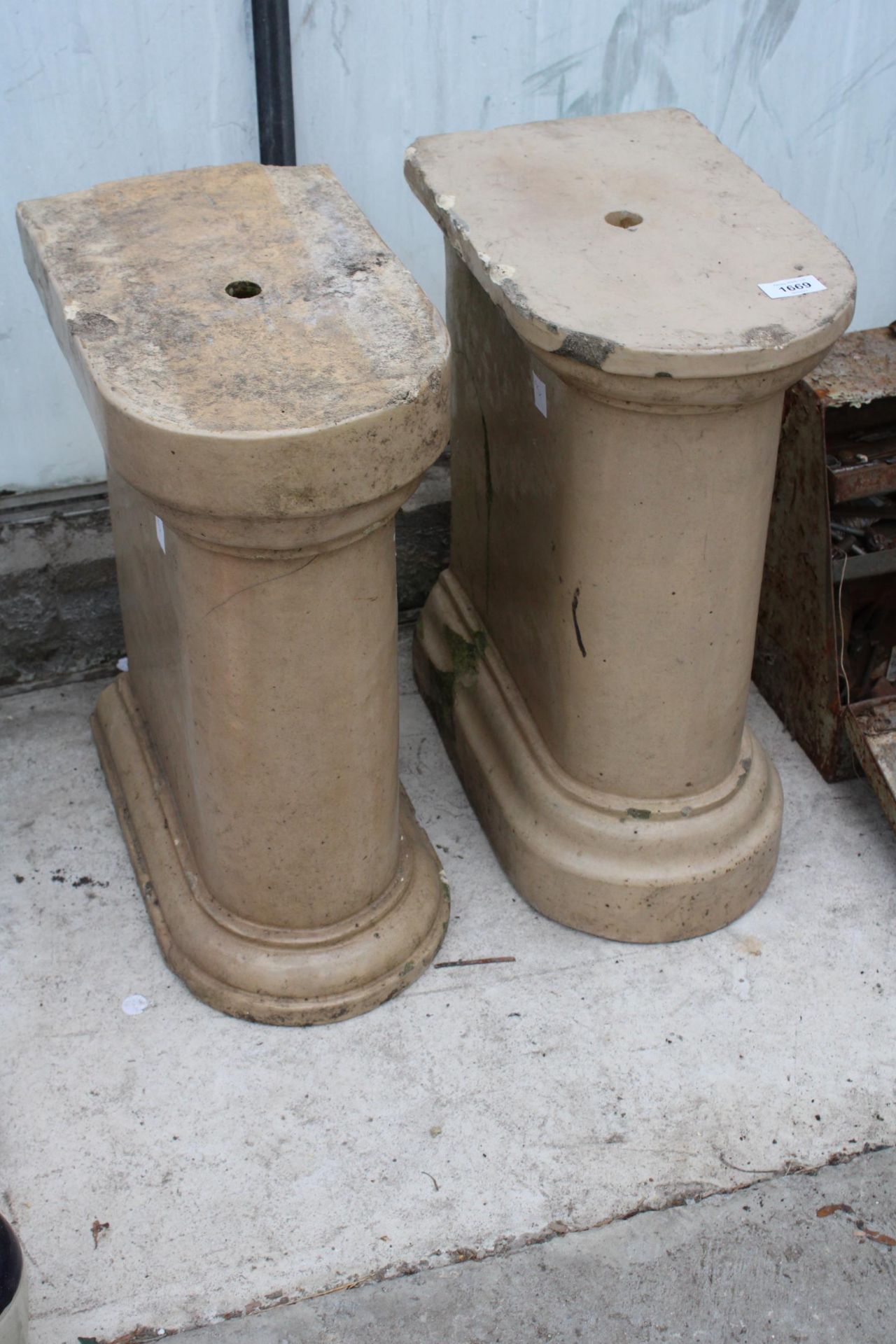 A PAIR OF RECONSTITUTED STONE AND GLAZED PEDESTAL BASES