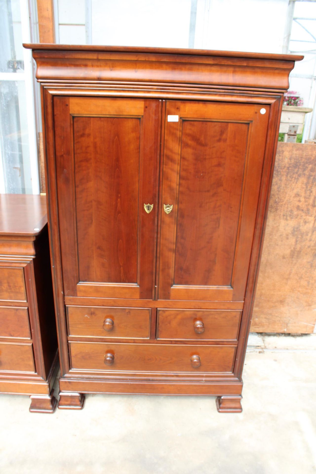 A SIMON HORN NURSERY COLLECTION PRESS STYLE TWO DOOR CUPBOARD WITH TWO SHORT AND TWO LONG DRAWERS TO