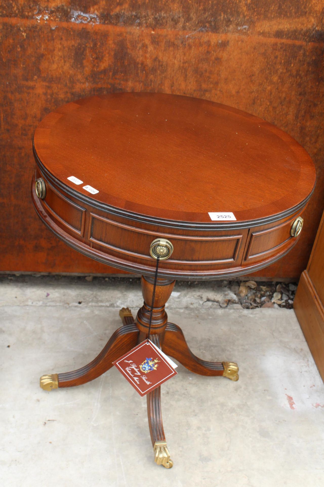 A MAHOGANY AND CROSSBANDED DRUM TABLE BY J. SYDNEY-SMITH ENCLOSING TWO DRAWERS 19.5" DIAMETER,