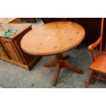 A MODERN 36" DIAMETER PINE DINING TABLE ON PEDESTAL BASE