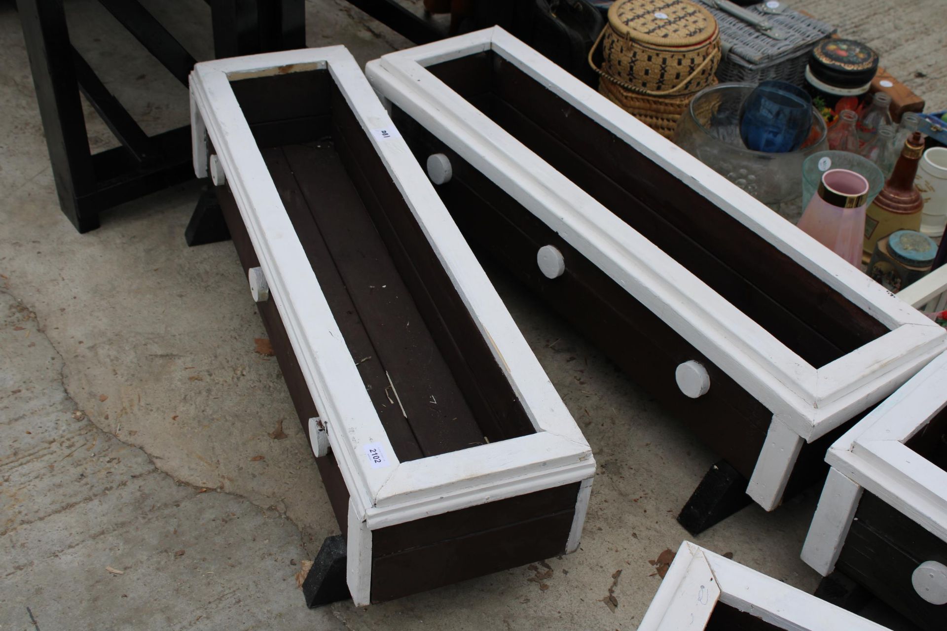 A PAIR OF WOODEN PAINTED GARDEN TROUGH PLANTERS