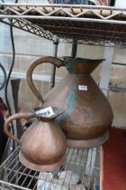 A LARGE VINTAGE COPPER HAYSTACK JUG AND A FURTHER SMALLER EXAMPLE