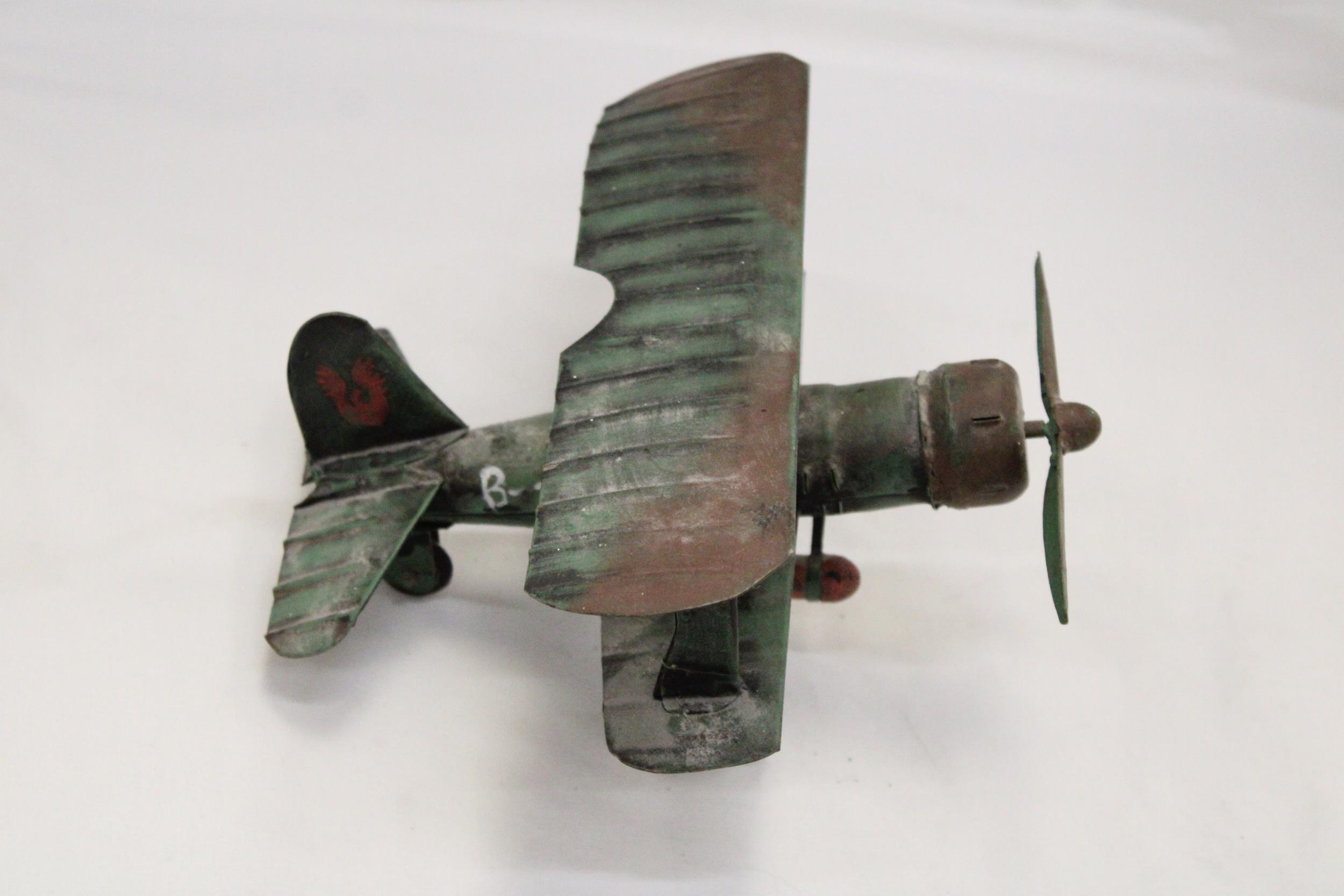 A U.S.A TIN PLATE BI-PLANE APPROXIMATELY 13CM HIGH BY 23CM LONG