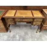 A MID 20TH CENTURY MAHOGANY KNEE HOLE DESK ENCLOSING SHORT AND ONE LONG DRAWER ON CABRIOLE LEGS WITH