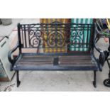 A DECORATIVE WOODEN SLATTED HEAVY CAST IRON TWO SEATER GARDEN BENCH