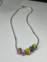 A SILVER PANDORA NECKLACE WITH FIVE GLASS CHARMS