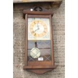 A WOODEN CASED QUARTZ WALL CLOCK