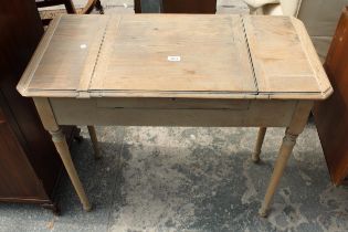 AN EARLY 20TH CENTURY OAK 'THE BRITISHER DESK' WITH FOLD-OUT WRITING AND STORAGE SECTIONS, 36" WIDE