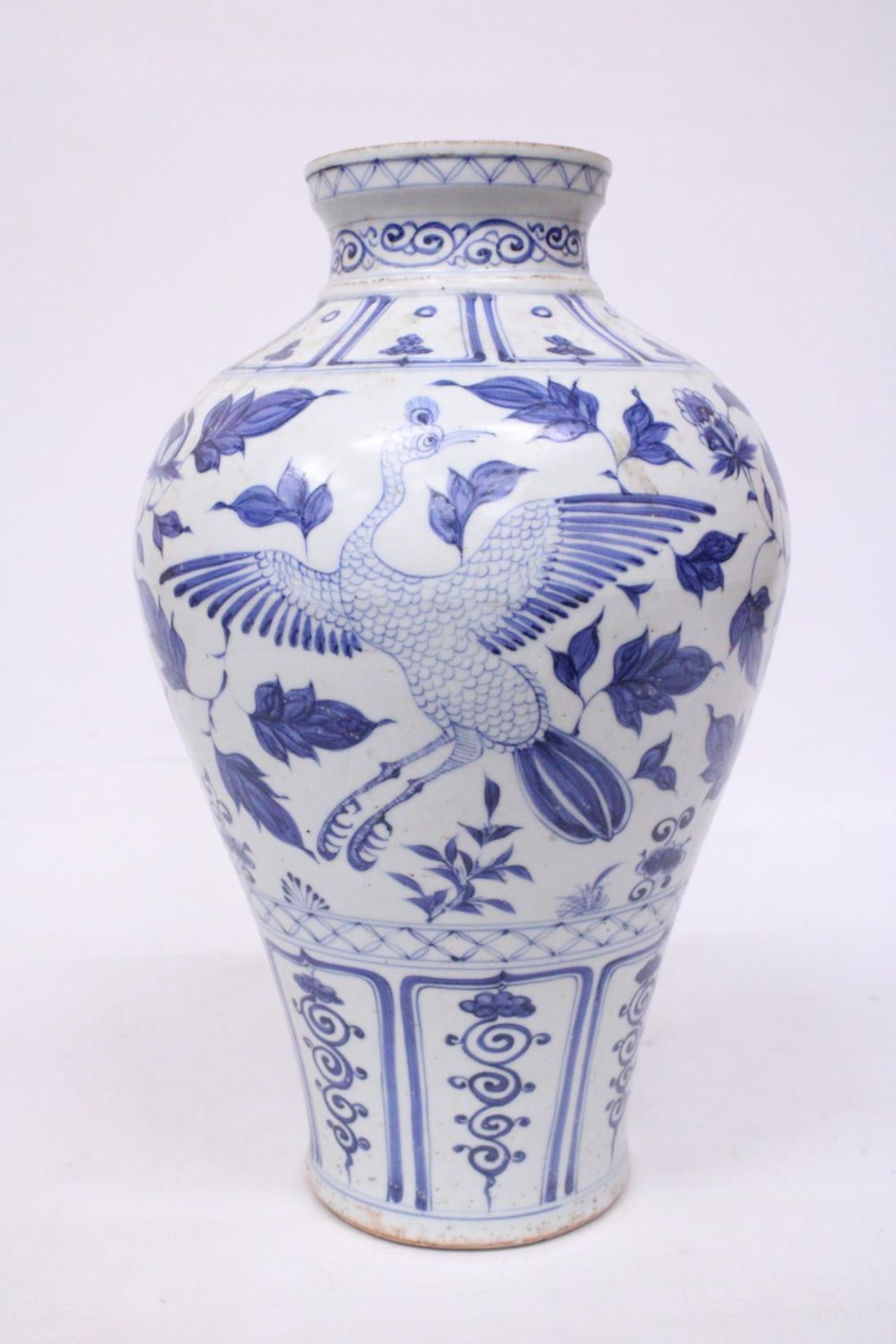 A LARGE CHINESE MING STYLE BLUE AND WHITE POTTERY MEIPING VASE DECORATED WITH CRANES IN FLIGHT -