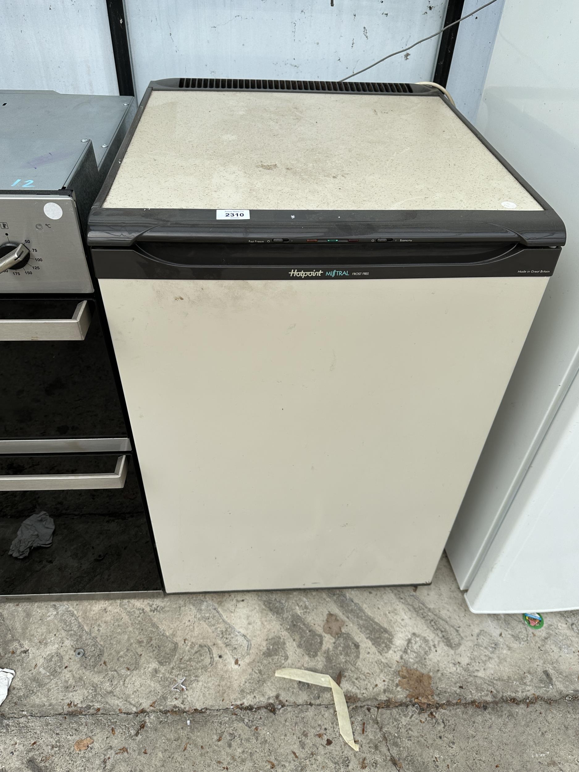 A BROWN AND CREAM HOTPOINT UNDER COUNTER FREEZER