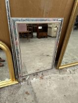 A RECTANGULAR FLORAL FRAMED MIRROR