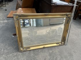 AN ORNATE RECTANGULAR GILT FRAMED MIRROR