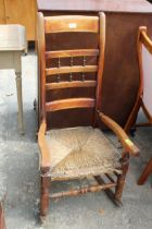 A 19TH CENTURY ROCKING CHAIR WITH RUSH SEAT