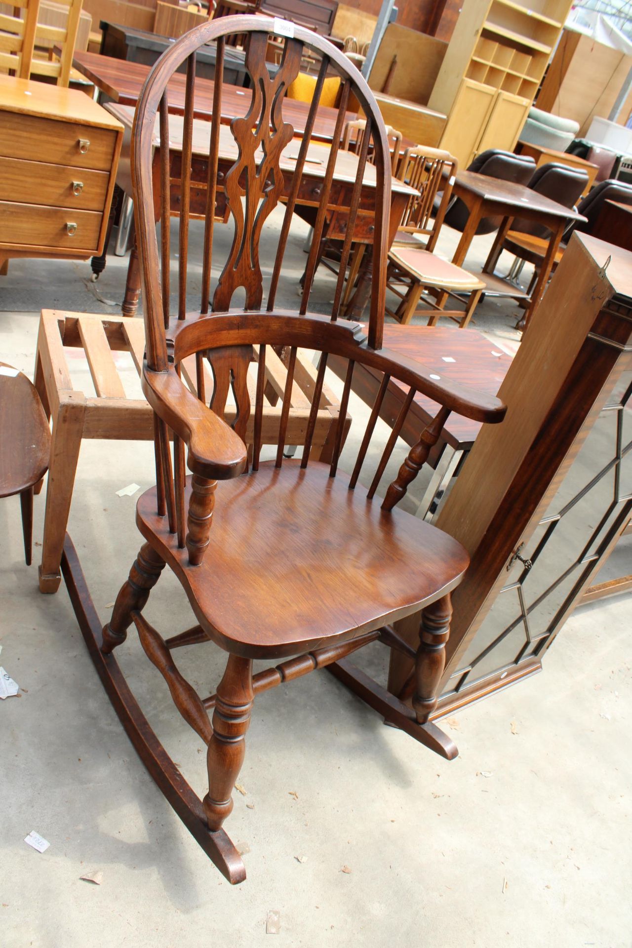 A WINDSOR STYLE ELM AND BEECH ROCKING CHAIR WITH PIERCED SPLAT HIGH BACK
