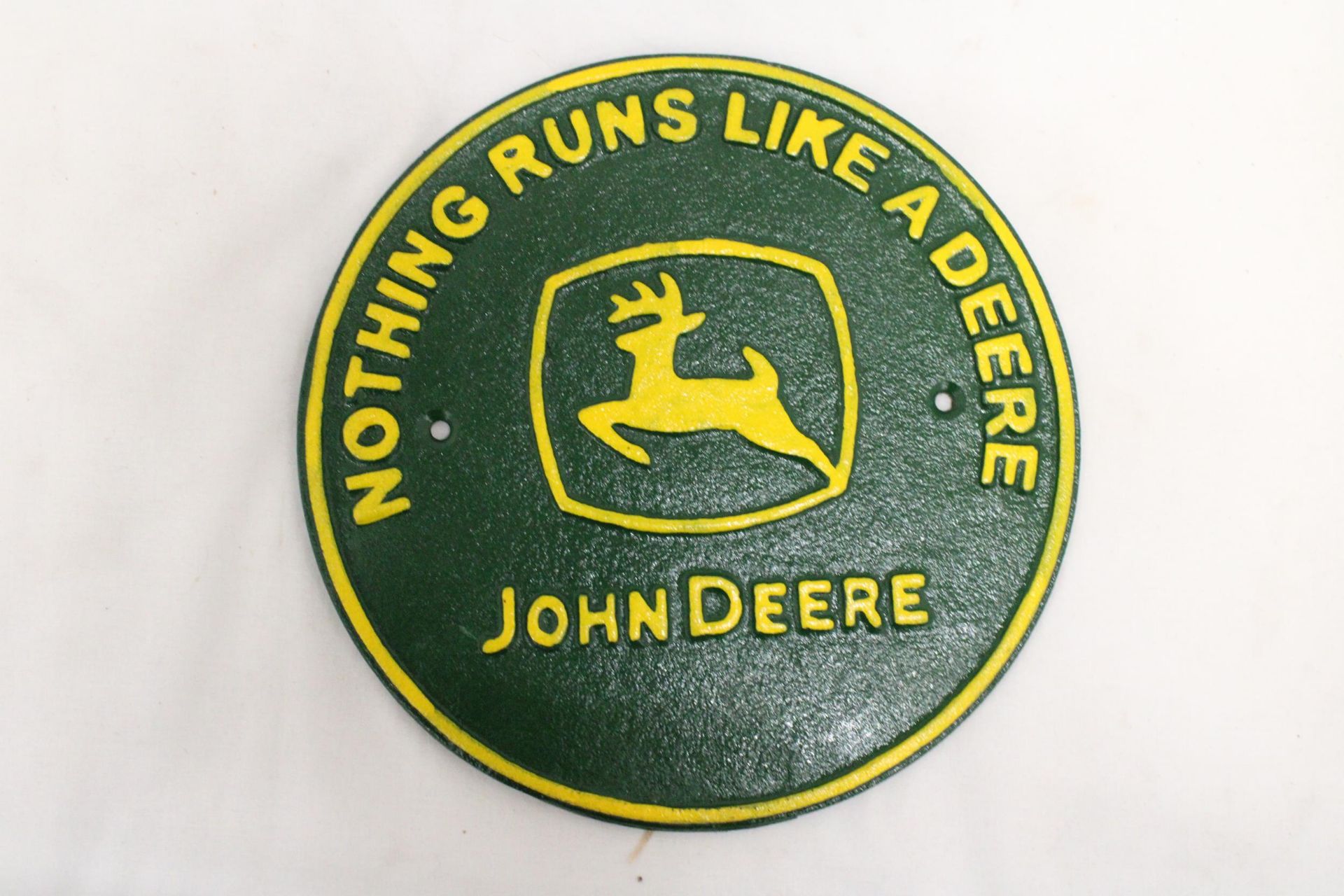 A CAST 'NOTHING RUNS LIKE A DEERE' CIRCULAR JOHN DEERE SIGN