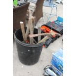 A PLASTIC BIN WITH AN ASSORTMENT OF TOOLS TO INCLUDE A PICK AXE AND A SHOVEL ETC