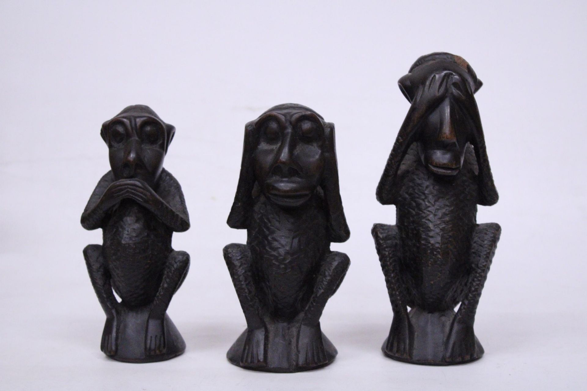 A SET OF THREE TRIBAL MONKEY FIGURES, HEAR NO EVIL, SPEAK NO EVIL AND HEAR NO EVIL