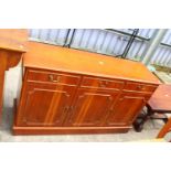 A MODERN YEW WOOD SIDEBOARD - 52" WIDE