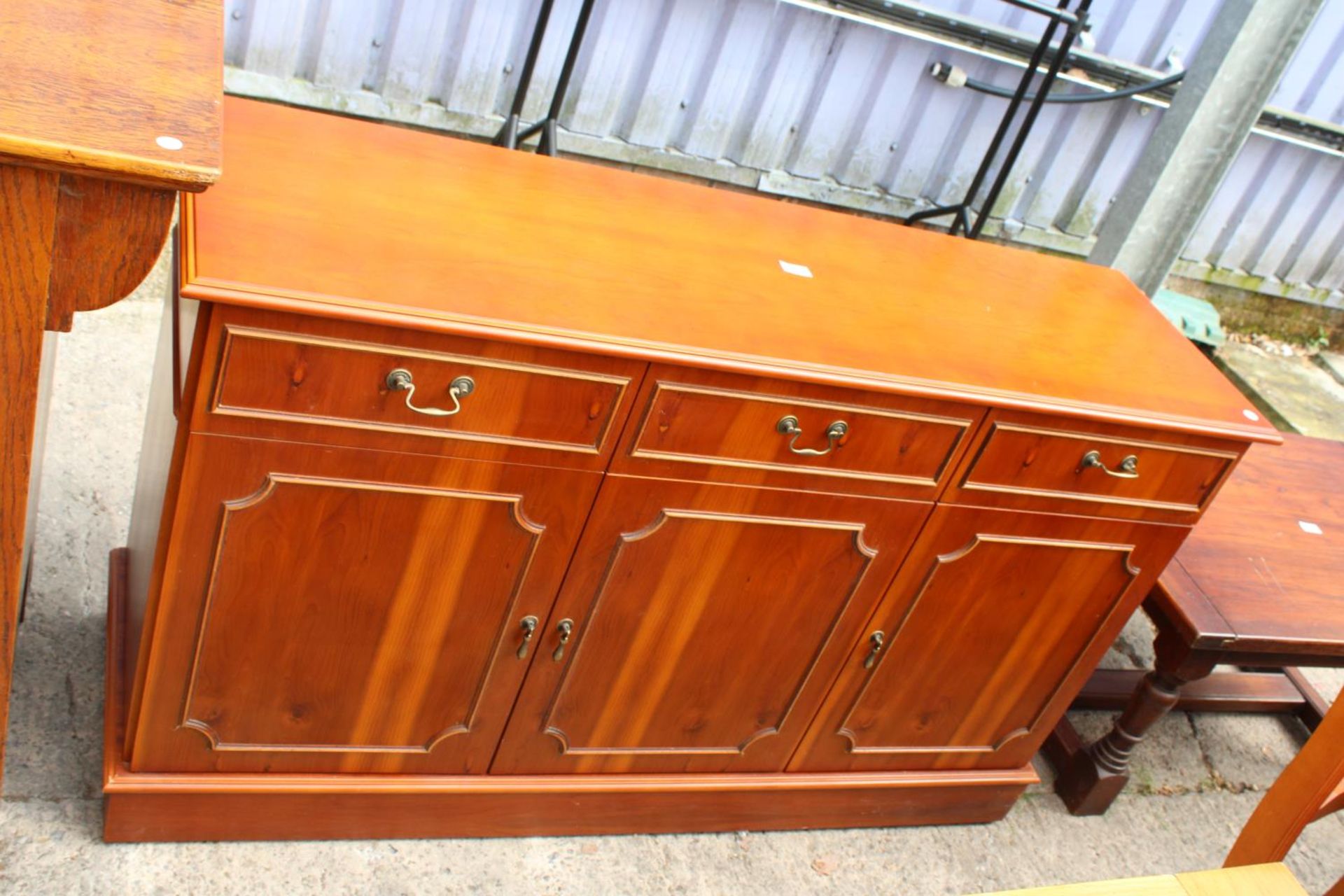 A MODERN YEW WOOD SIDEBOARD - 52" WIDE