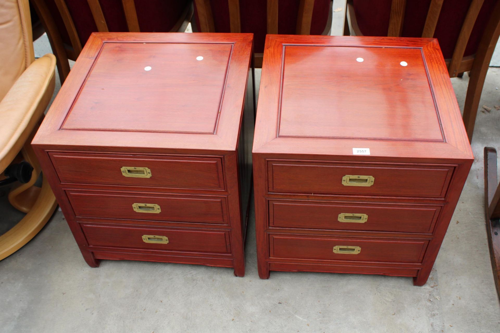 A PAIR OF MODERN HARDWOOD BEDSIDE CHESTS WITH THREE DRAWERS AND BRASS CAMPAIGN STYLE HANDLES
