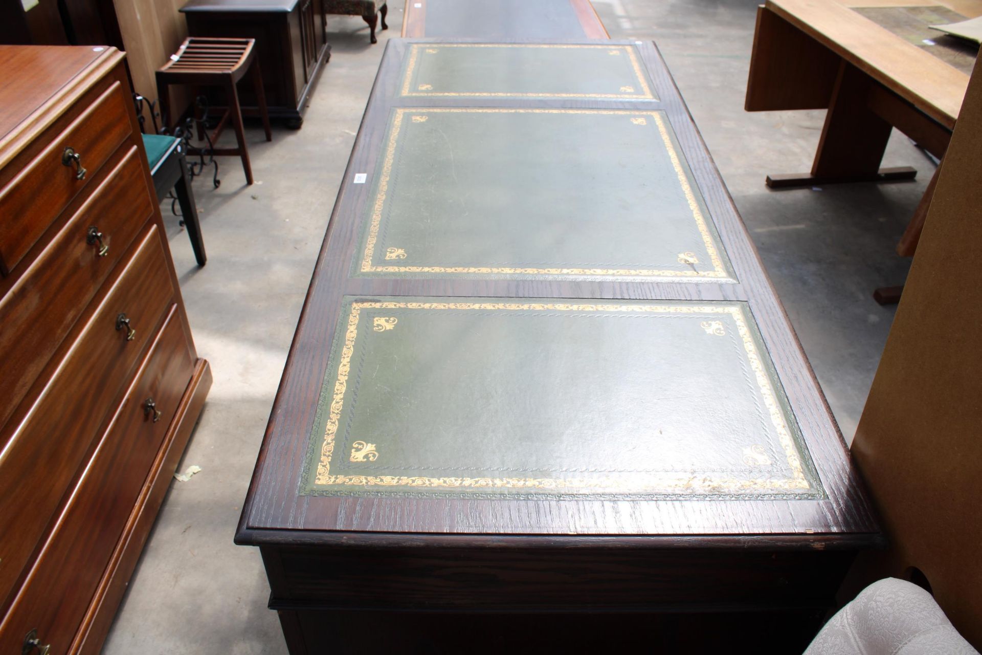 AN OAK JAYCEE TWIN-PEDESTAL DESK, TWO CARVED CUPBOARDS AND THREE DRAWERS WITH INSET LEATHER TOP, 68" - Image 2 of 3