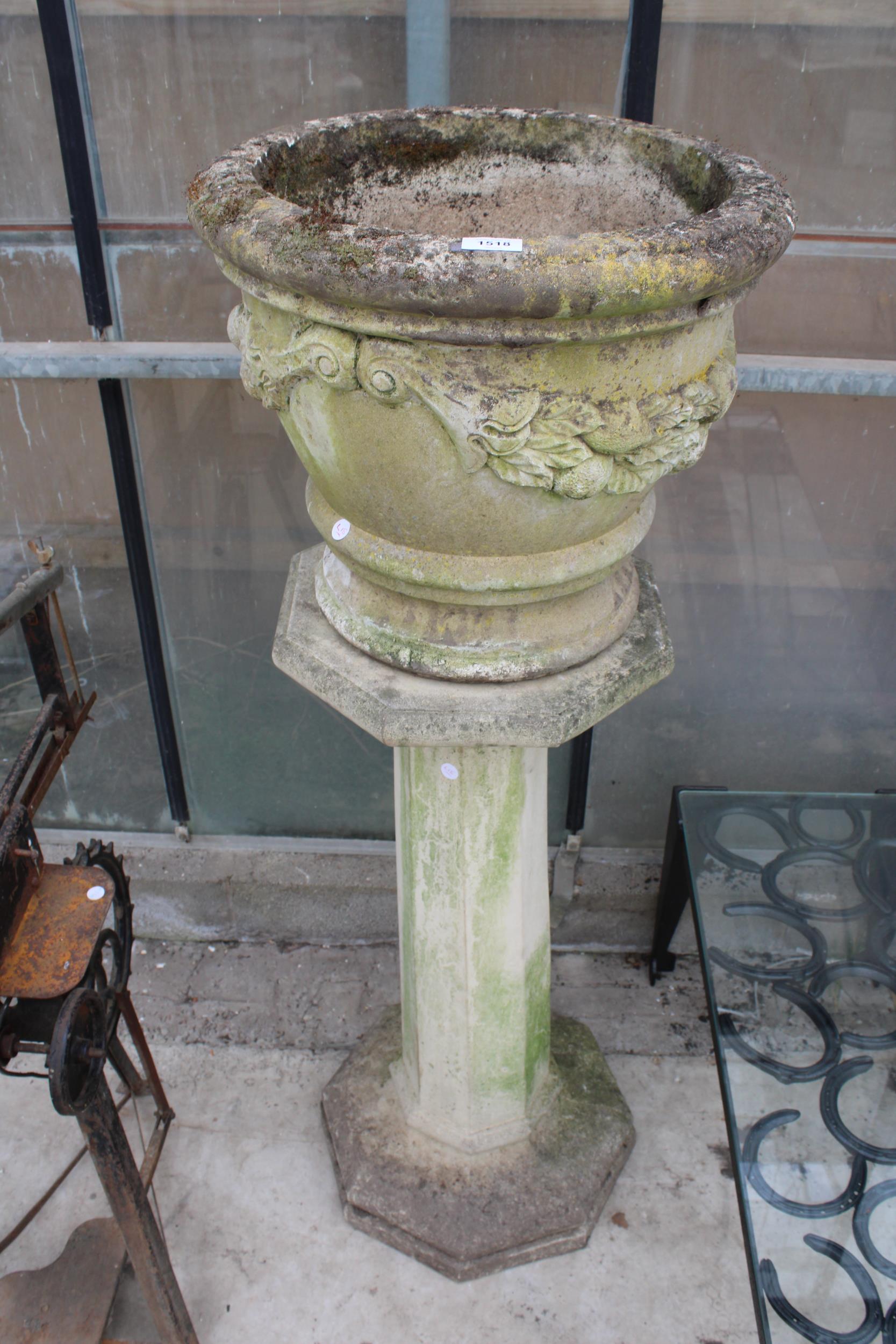 A LARGE RECONSTITUTED STONE PLANTER ON COLUMN PEDESTAL BASE (H:132CM)