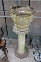 A LARGE RECONSTITUTED STONE PLANTER ON COLUMN PEDESTAL BASE (H:132CM)