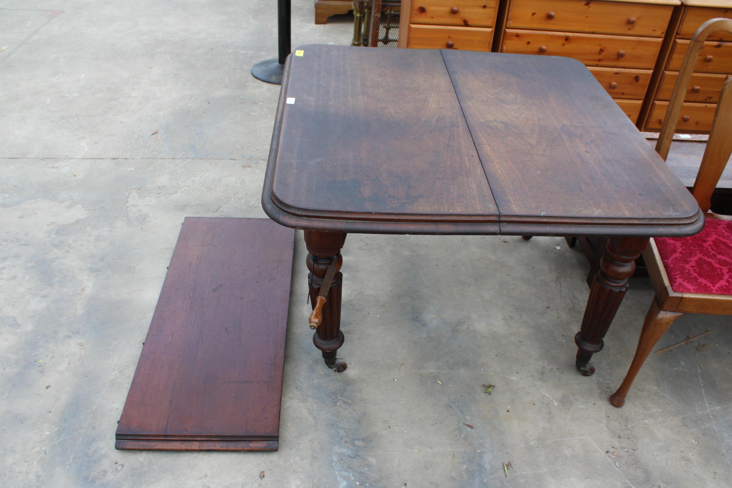 A VICTORIAN MAHOGANY WIND-OUT DINING TABLE ON FLUTED LEGS, 41" SQUARE (LEAF 17") COMPLETE WITH