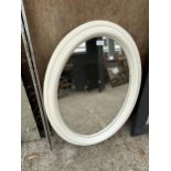 A WHITE FRAMED OVAL MIRROR