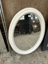 A WHITE FRAMED OVAL MIRROR