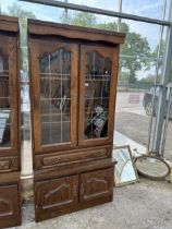 AN OAK CABINET WITH GLAZED AND LEADED UPPER PORTION, 37" WIDE