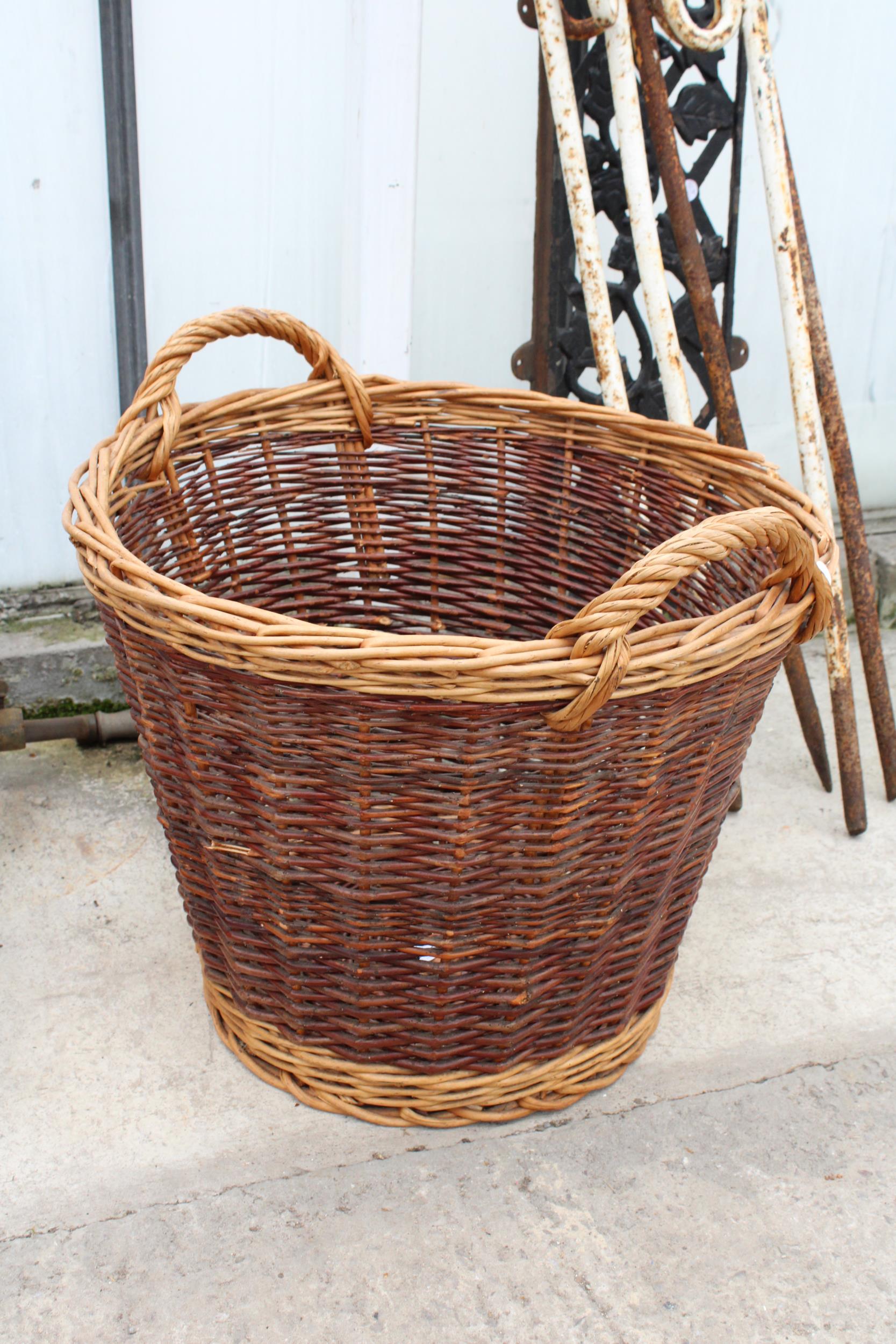 A VINTAGE WICKER TWIN HANDLED LOG BASKET