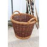 A VINTAGE WICKER TWIN HANDLED LOG BASKET