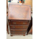 A REPRODUCTION WALNUT AND CROSS BANDED BUREAU 20" WIDE