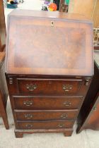 A REPRODUCTION WALNUT AND CROSS BANDED BUREAU 20" WIDE