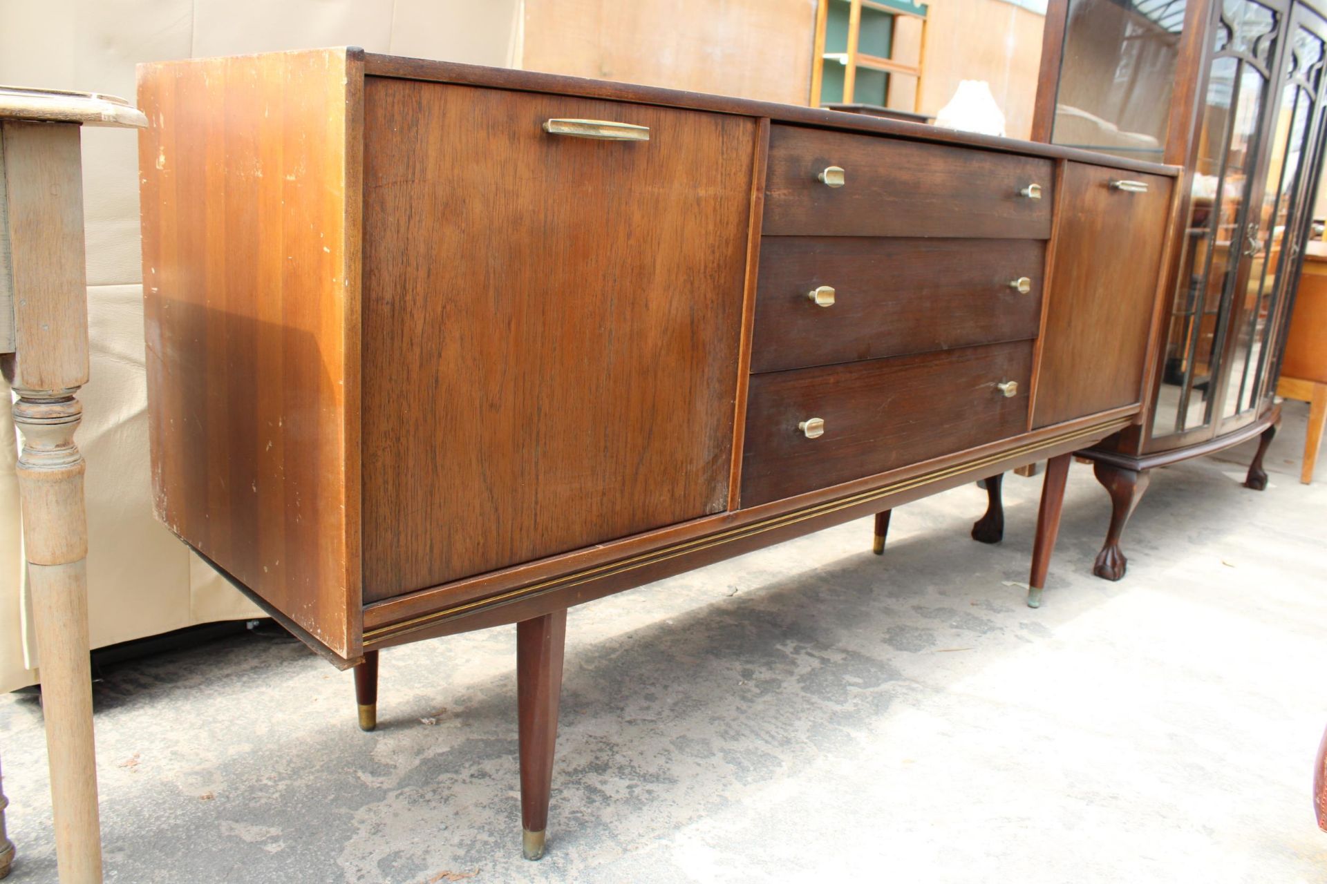A RETRO TEAK SIDEBOARD ENCLOSING THREE DRAWERS AND TWO DROP-DOWN CUPBOARDS, 65" WIDE - Bild 2 aus 4