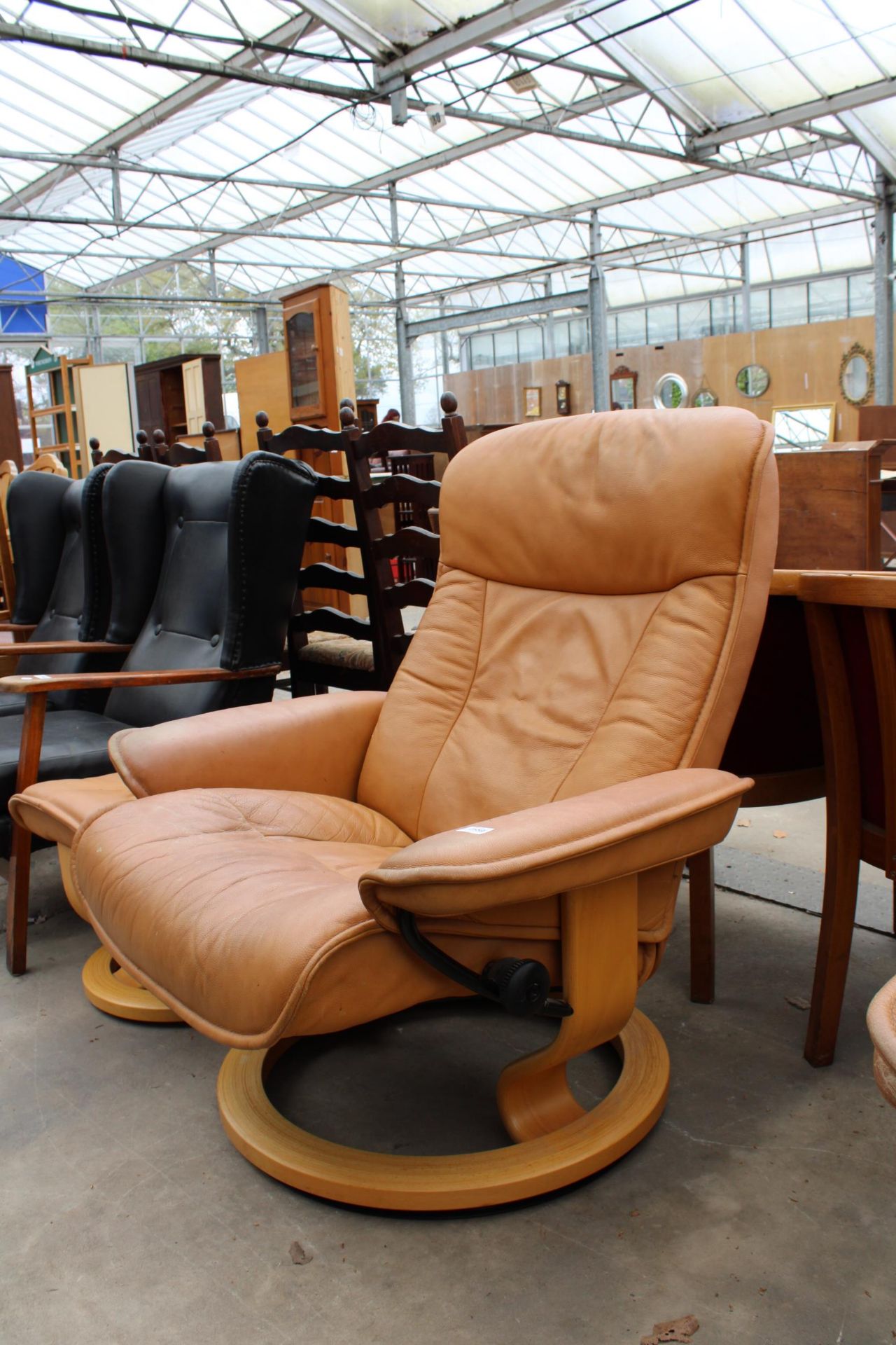 A STRESSLESS EKORNES TANNED LEATHER SWIVEL RECLINER WITH STOOL - Image 2 of 4