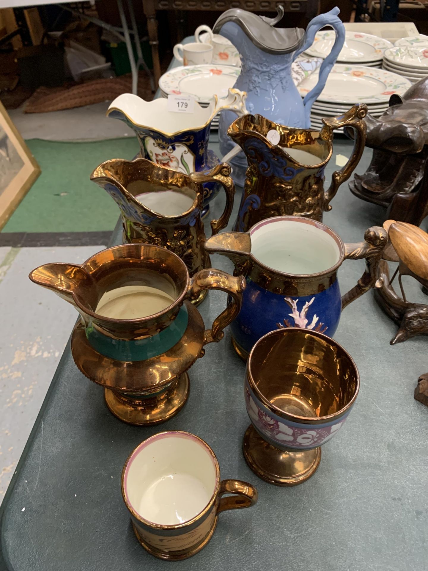 SIX VINTAGE JUGS, A GOBLET AND A MUG TO INCLUDE A WATER JUG WITH CHERUBS AND PEWTER LID, COPPER