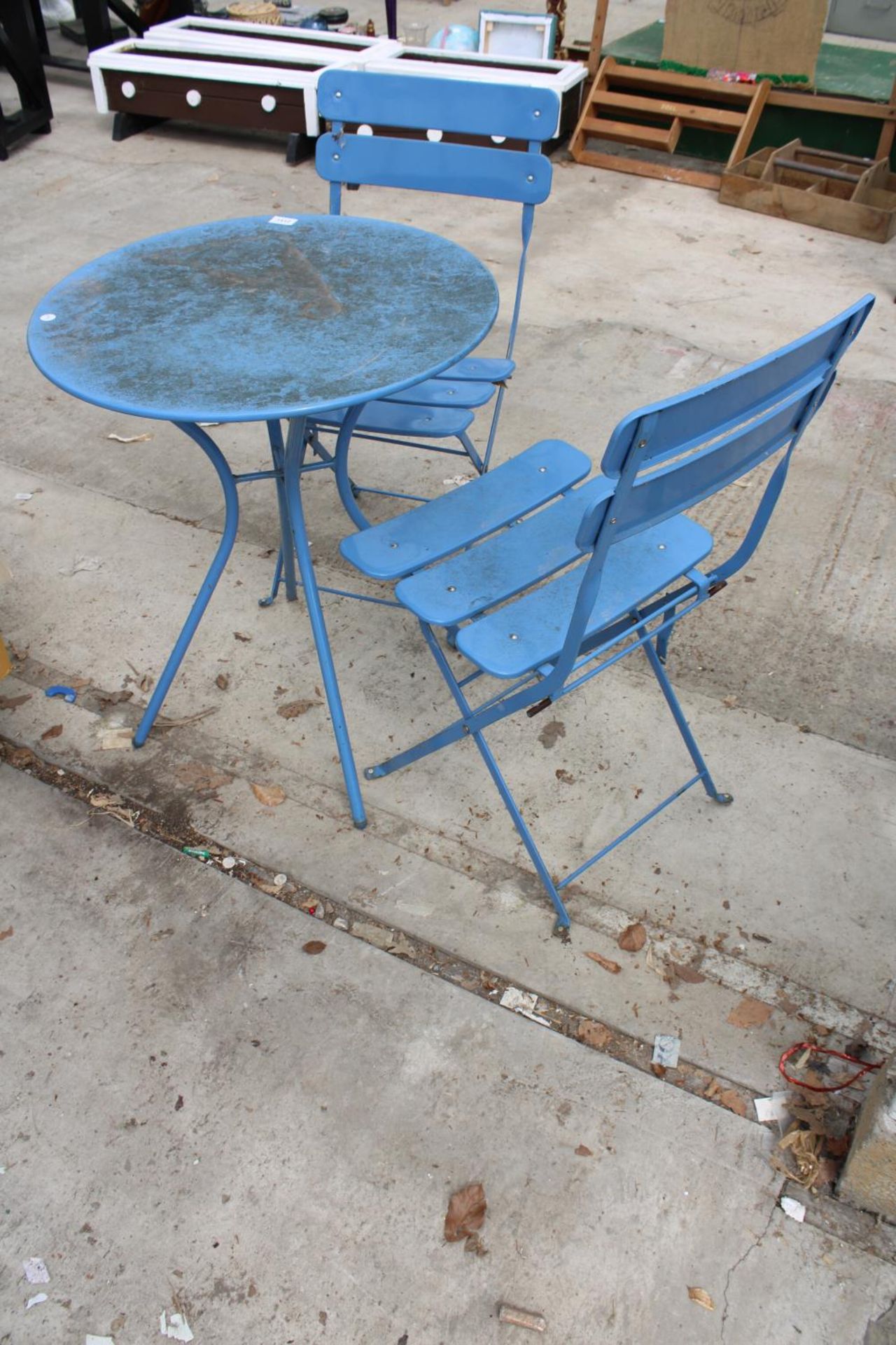 A BLUE METAL BISTRO TABLE AND TWO MATCHING FOLDING CHAIRS - Image 2 of 2