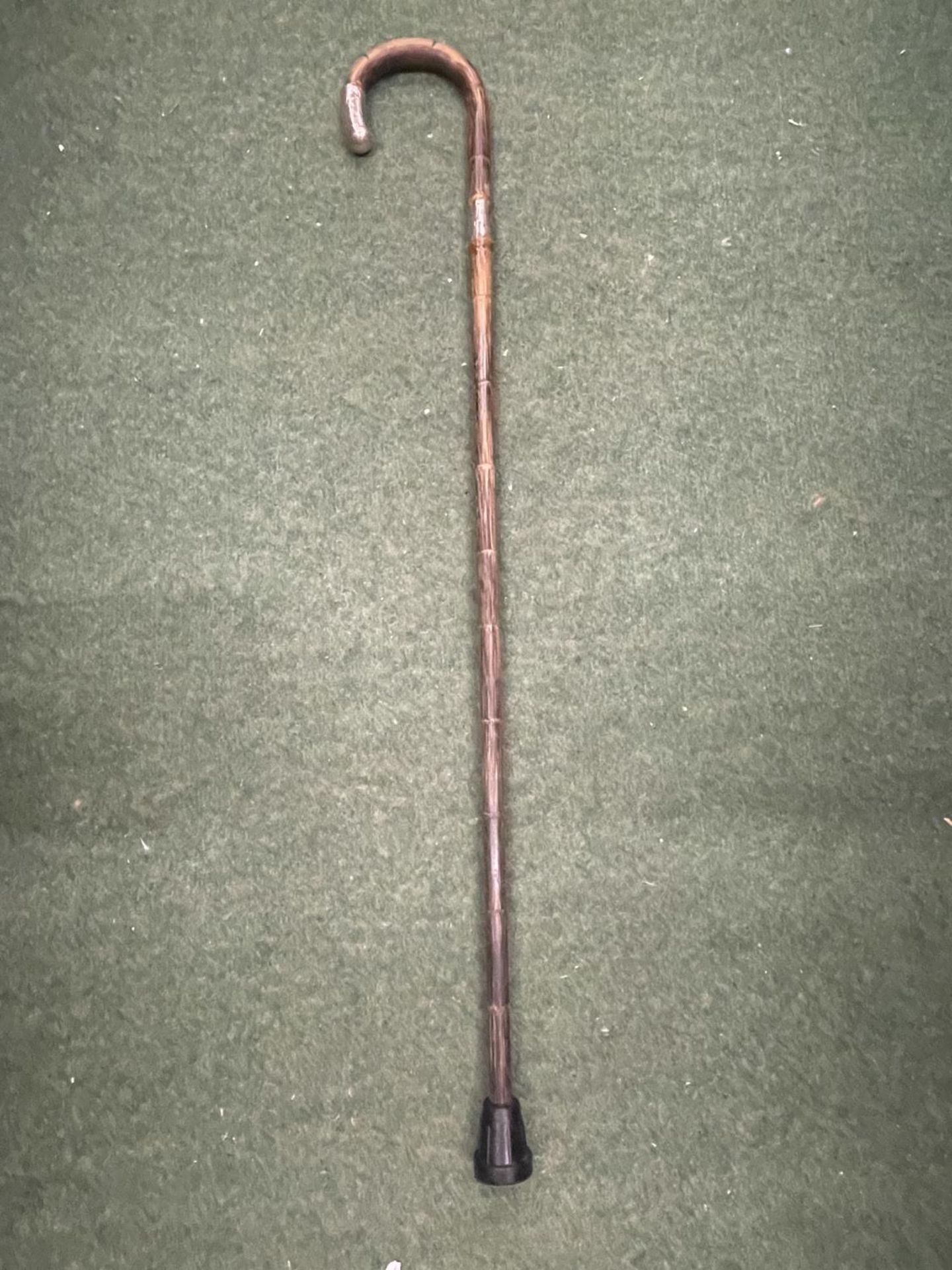 A WALKING CANE WITH A HALLMARKED SILVER FERRULE AND HANDLE TIP