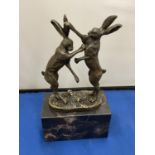 A PAIR OF BRONZE BOXING HARES ON A MARBLE BASE