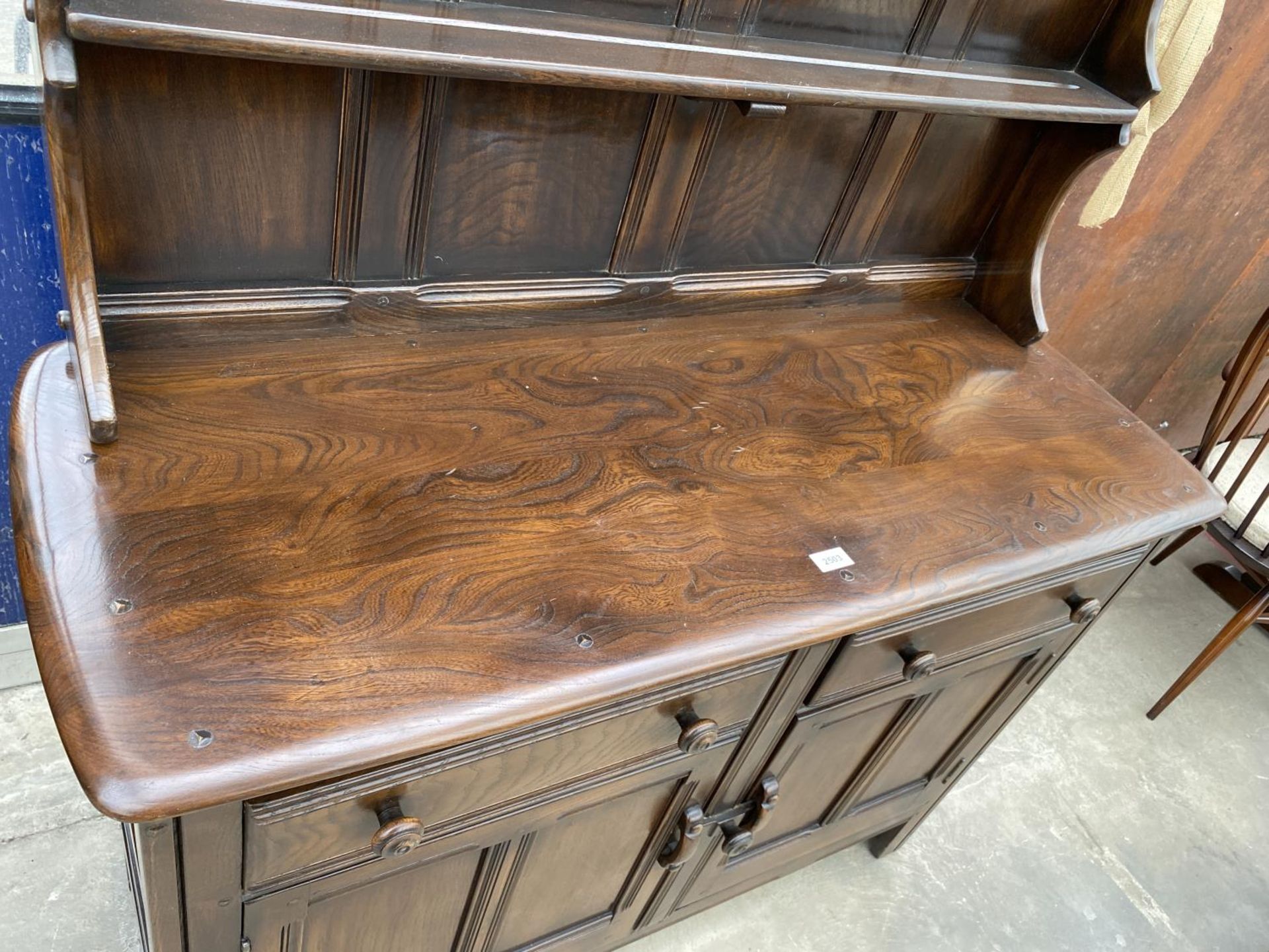 AN ELM ERCOL BLUE LABEL DRESSER ENCLOSING TWO DRAWERS AND TWO CUPBOARDS WITH PLATE RACK, 48" WIDE - Image 3 of 8