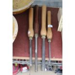 FOUR LARGE WOODEN HANDLED LATHE TOOLS AND CHISELS