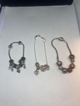 THREE SILVER CHARM BRACELETS TO INCLUDE A DISNEY EXAMPLE