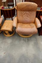A STRESSLESS EKORNES TANNED LEATHER SWIVEL RECLINER WITH STOOL